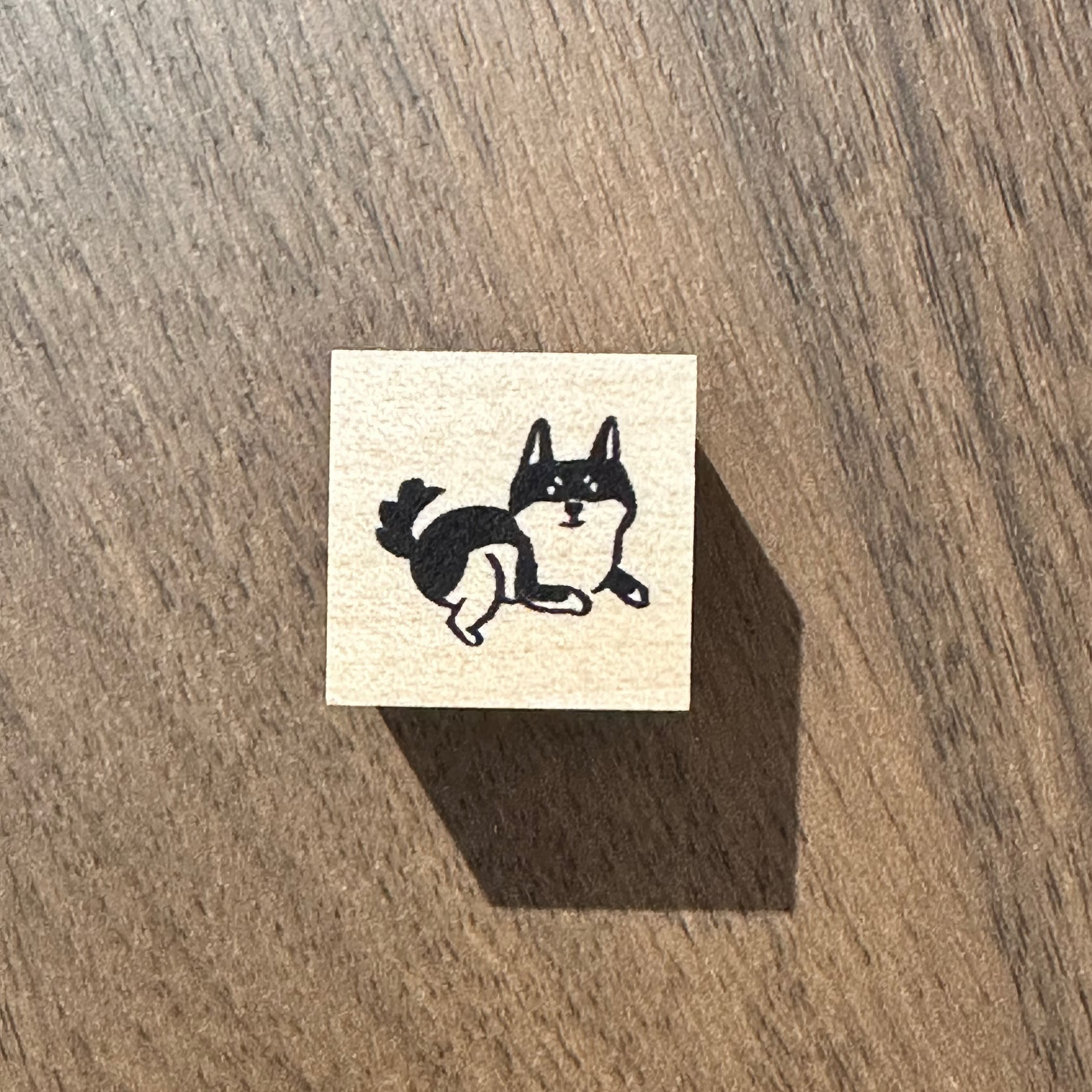 Rubber stamp on a wooden surface with a dog design 